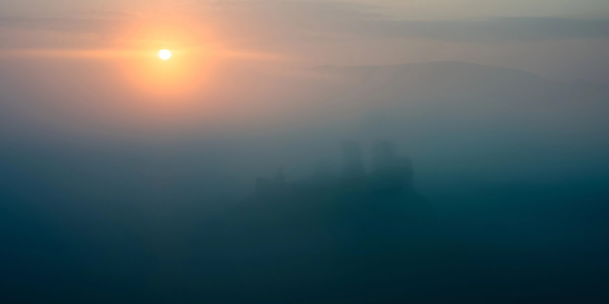 Sunrise breaking through morning mist
