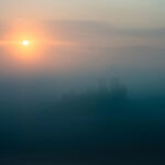 Sunrise breaking through morning mist